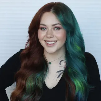 a woman with brown and green hair smiling