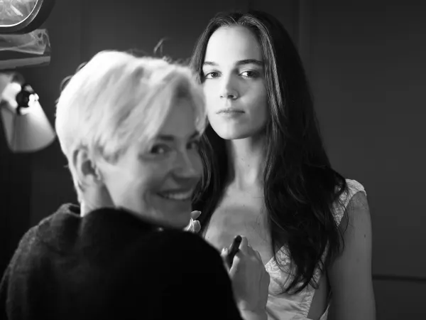 A female hairstylist works with a female model