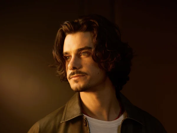 A male model with short curly hair