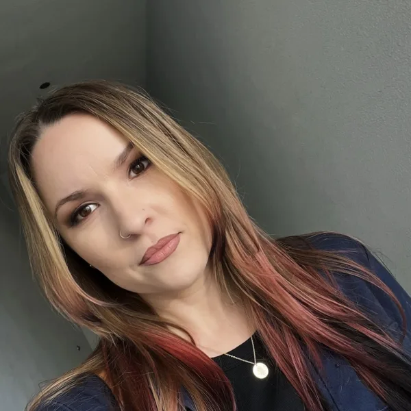 A young woman with hair that has panels of red and yellow. 
