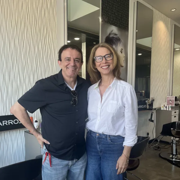 A man and a woman standing inside a salon