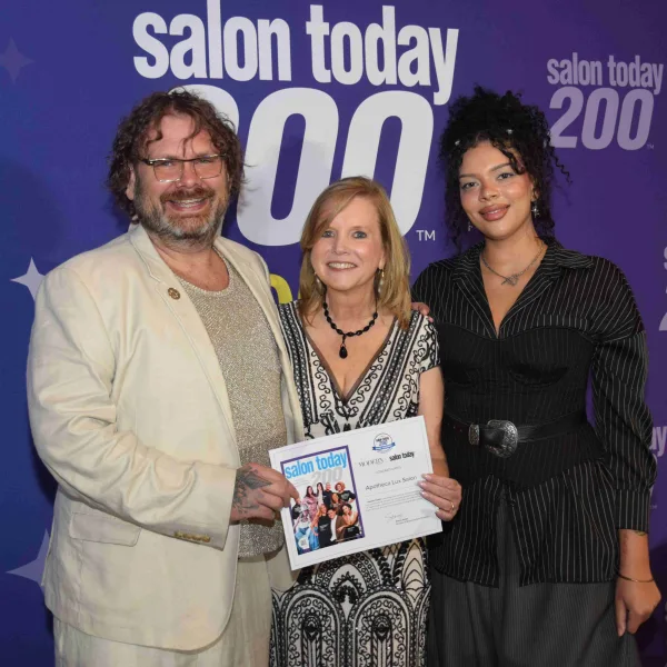 The honorees from Apotheca Lux Salon accept their award.