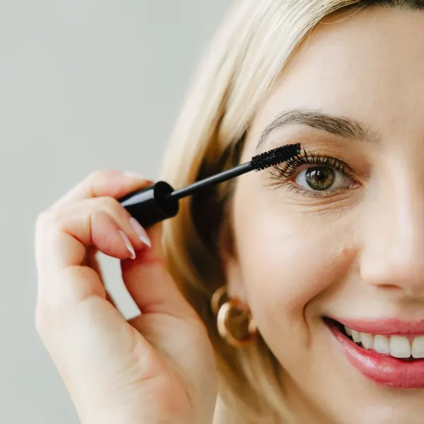 Woman applying mascara