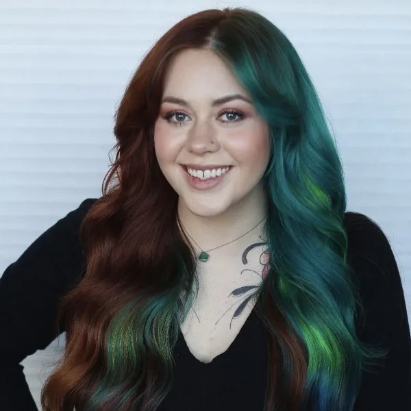 a woman with brown and green hair smiling