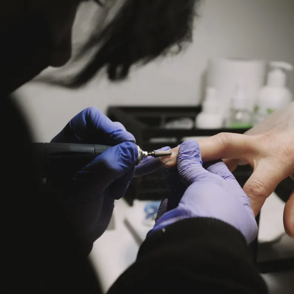 A nail tech doing a client's nails