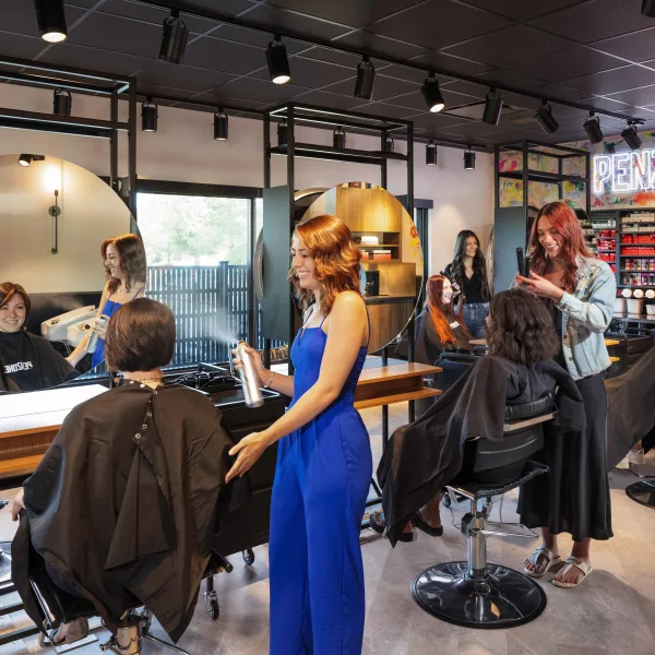 Stylists work with clients inside the training salon within BASE ONE, the PENZONE Salons+Spas' training center in Columbus, Ohio.