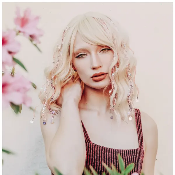 A blonde haired woman with tinsel strands.