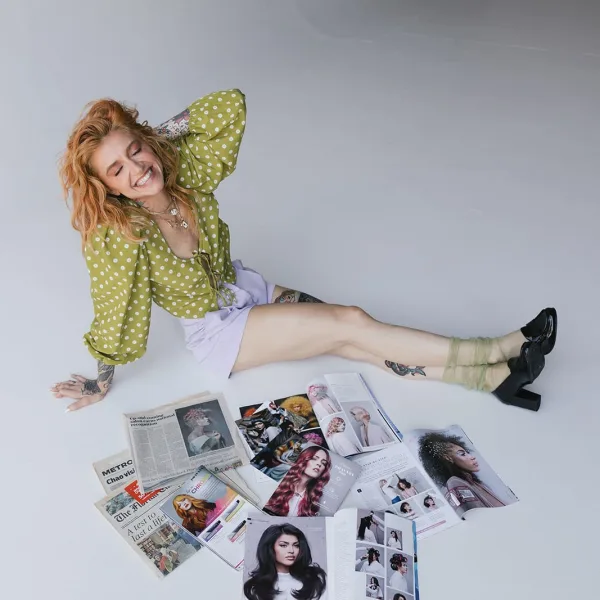 A woman surrouneded by magazines
