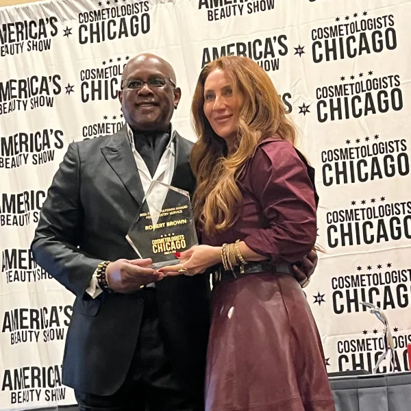 Robert Brown is presented his award by Anna Manukyan, Treasurer, Cosmetologist Chicago Board Member