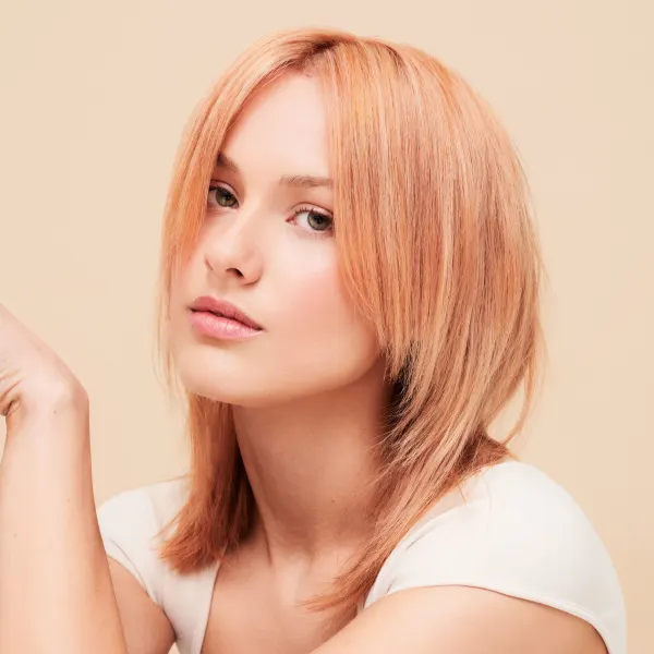 A woman with peach-colored hair.