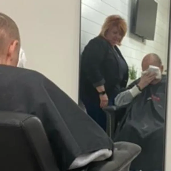 A hairstylist and her client, sitting in a chair