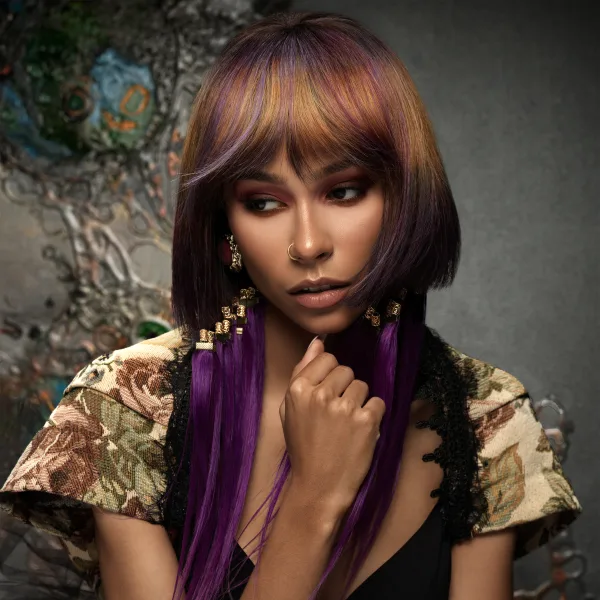 A woman with hair jewelry and multi-tonal haircolor.