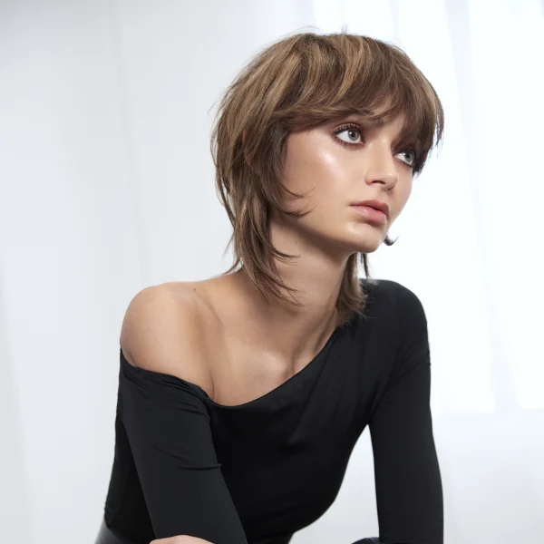 A woman in all black with a short haircut.