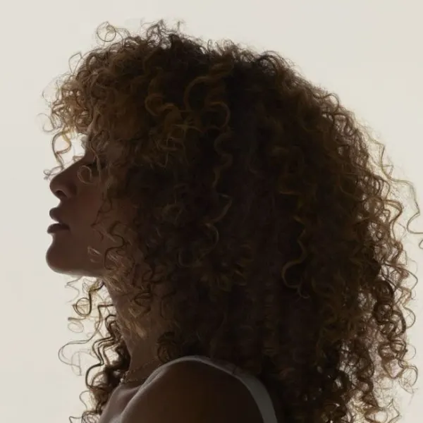 A woman with curly hair in profile.