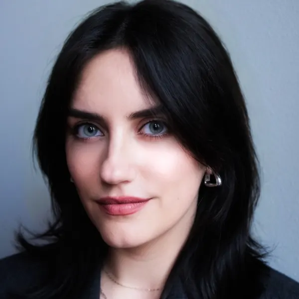 A woman in a suit jacket with dark hair