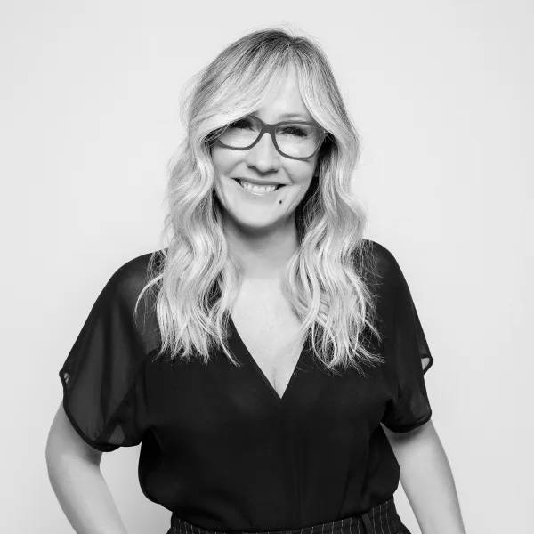 A smiling woman in glasses