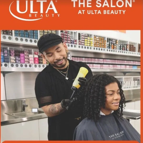 A photo of a hairstylist working on a client in a salon.