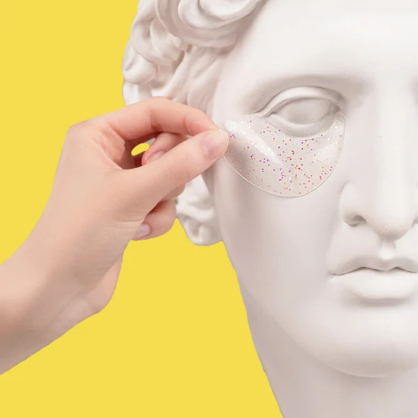 A marble statue has eyelid mask applied