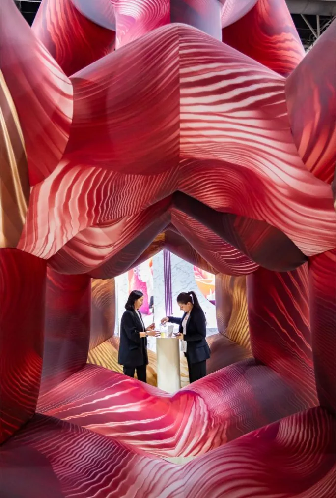 Trade show booth display with branding, product shelves, and visitors browsing at Beautyworld Middle East 2025.