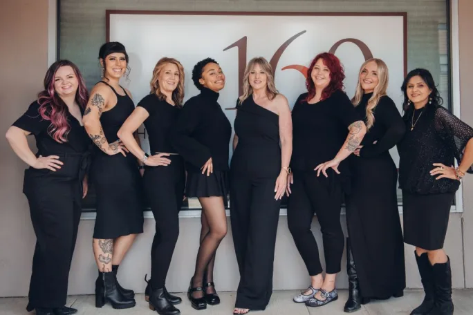 Standing in front of the salon, the team from 1630 Hair Artisans.