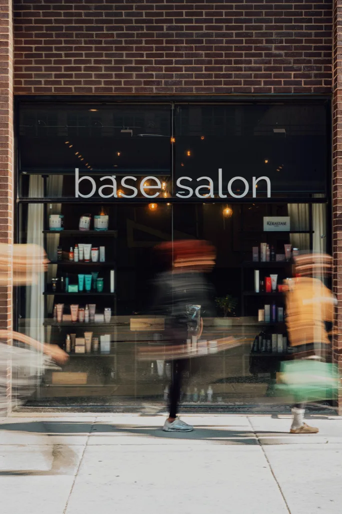 Blurred images of passersby outside Base Salon