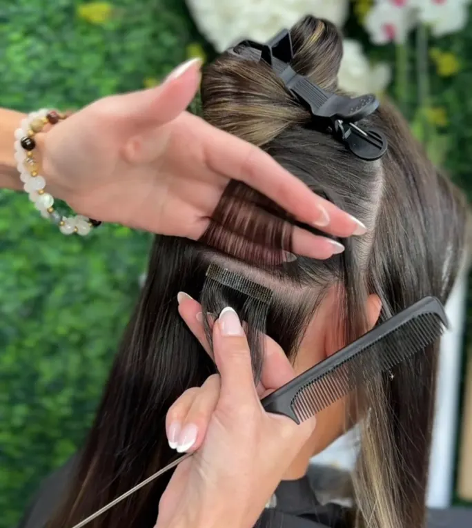 hands installing a tape-in extension
