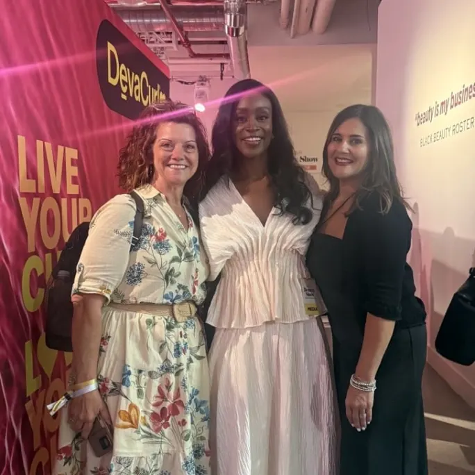 three women standing together for a photo