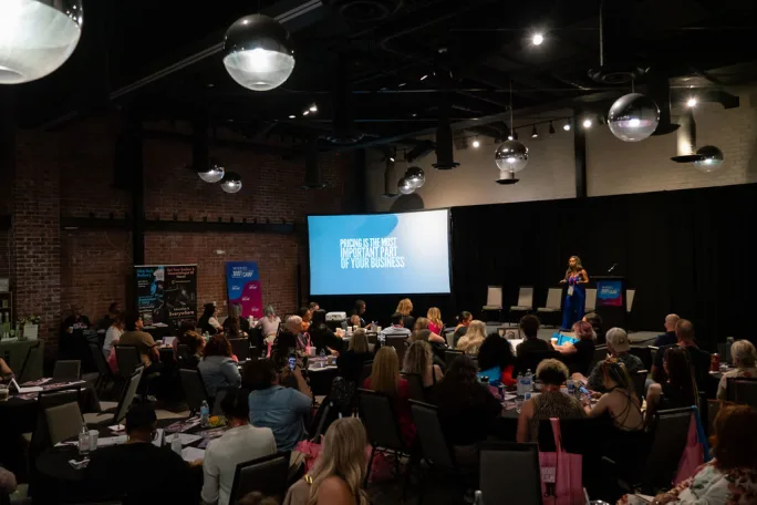 a woman presents to a room of attendees