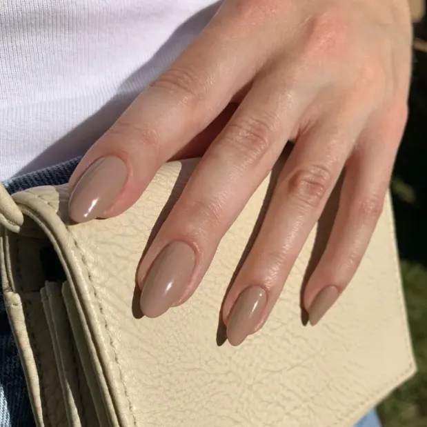A closeup of a hand on a purse