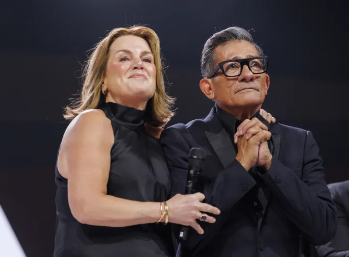 a woman standing next to a man
