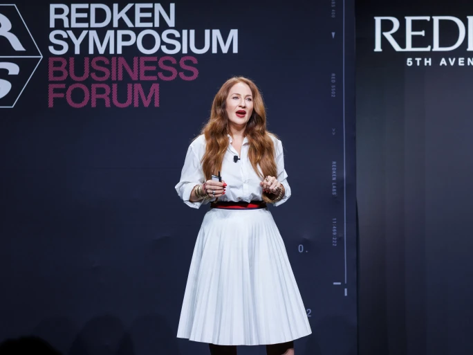 a woman giving a presentation onstage