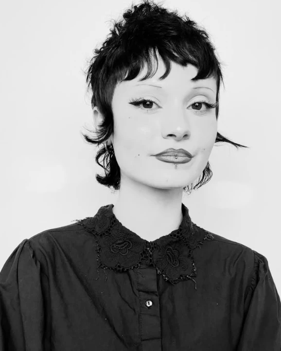 A young woman with a short haircut.