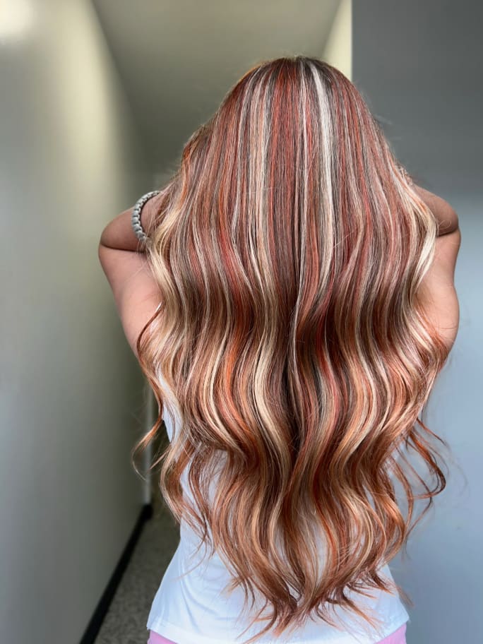 a woman with long red hair, back facing the camera