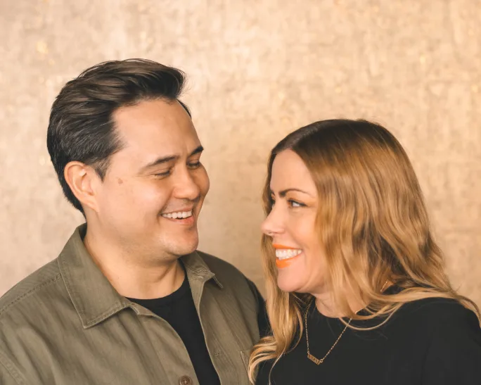 Rudy Moser and his wife Amy Daniel-Moser gaze lovingly at each other.