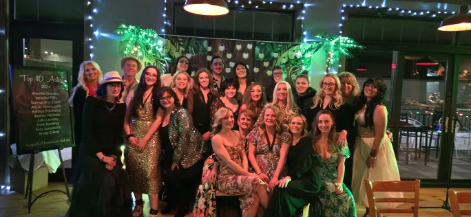 A large group of stylists in cocktail attire at a night of celebration event.