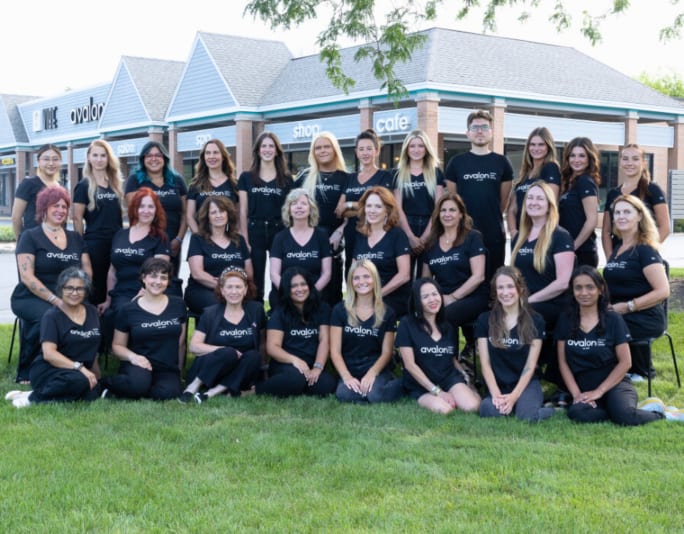 Dressed in identical Avalon Salon T-shirts, a large team of stylists.