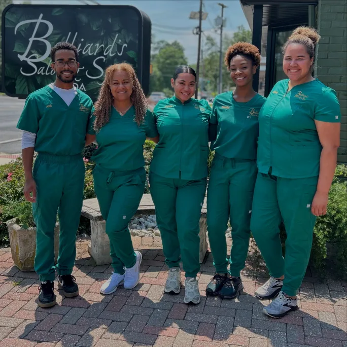 Dressed in green scrubs, estheticians from Belliard's Salon and Spa.
