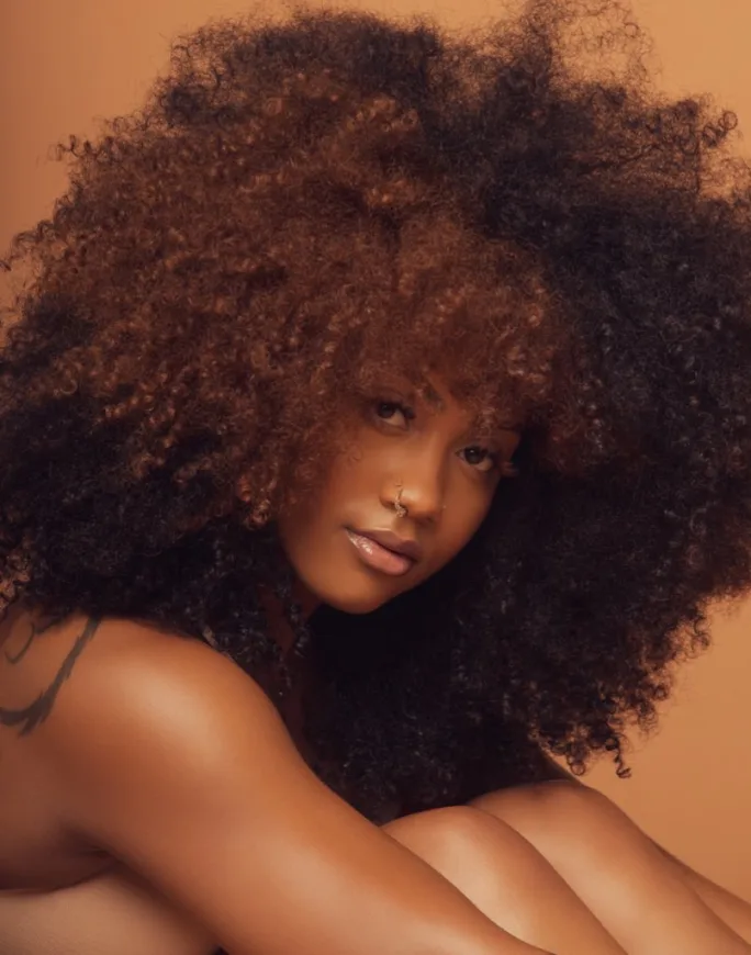 A young woman with curly hair