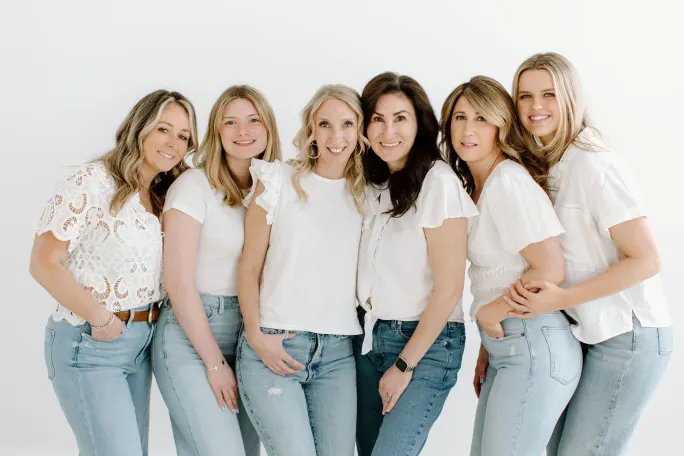 Dressed in white shirts and light colored jeans, six stylists.