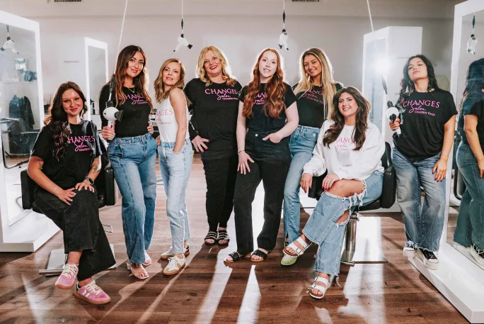 While a few stylists are armed with blow dryers, the team from Changes Salon Inc poses.