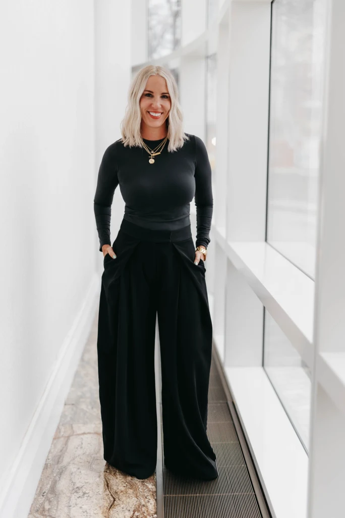Urban Betty's Chelle Neff stands confidently in the hallway of one of her salons.