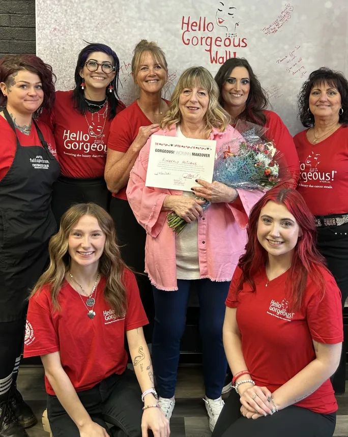 The team from Custom Cut & Style pose with one of a cancer patient whom they did a makeover for through Hello Gorgeous.
