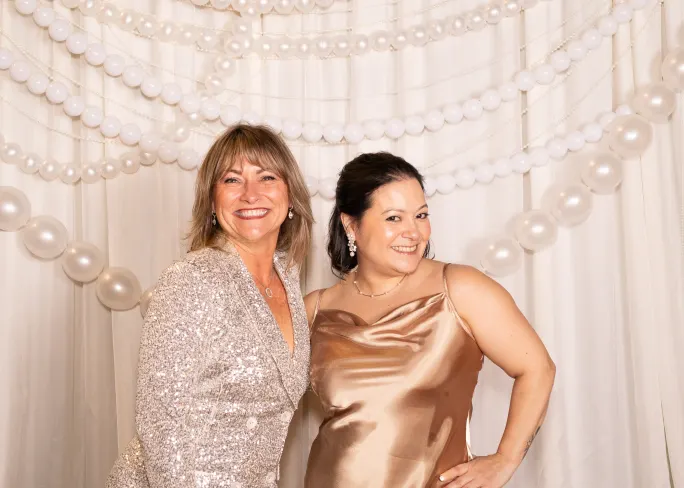 Cynthia Perry and Karla Patterson dressed in champagne-colored sparkle shine like the strong women they are.