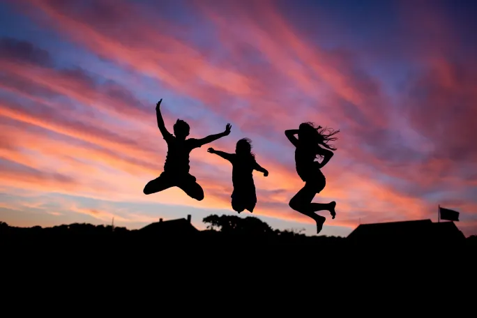 three people jumping in the air