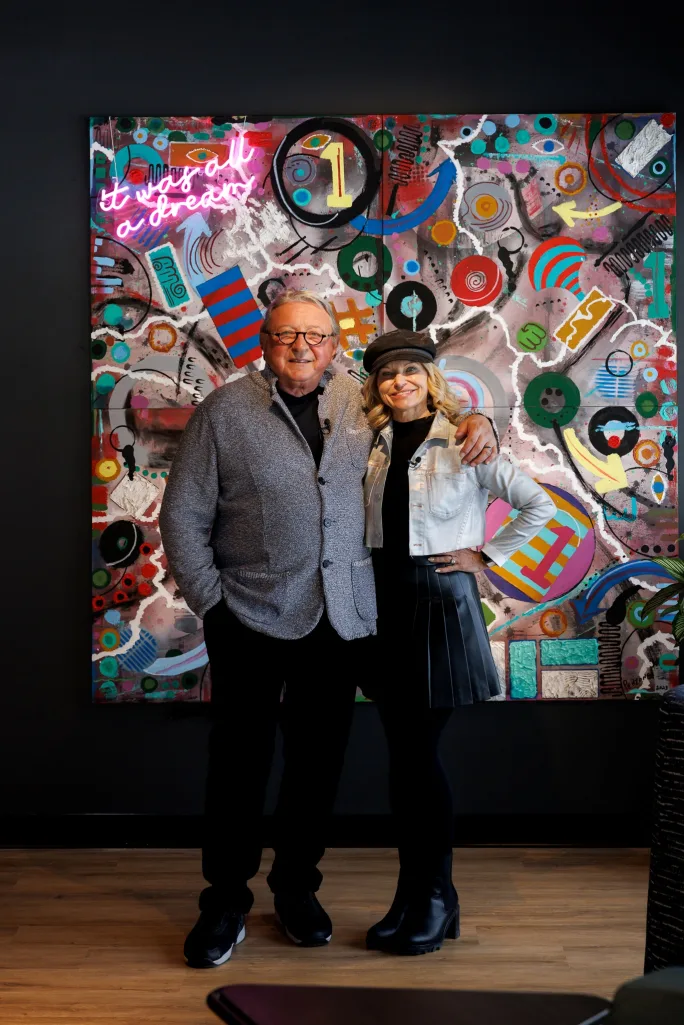 Charles and Debra Penzone in front of his original artwork.