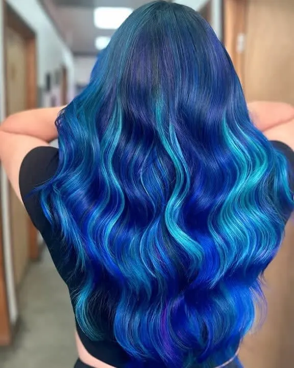 Very vibrant blue hair, very long and wavy.