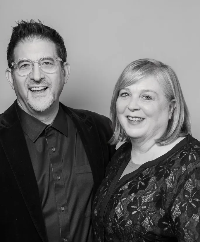 Smiling in a black and white portrait, Tony and Pam Gordon.