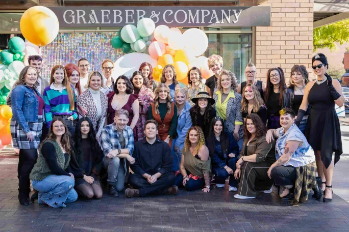 Celebrating their grand opening with balloons, the team from Graeber & Company pose in Boise, Idaho.