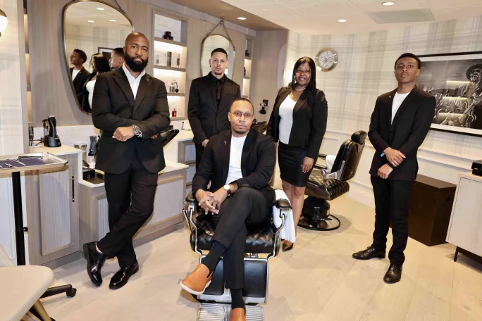 A group of impeccably dressed barbers at Groom Guy