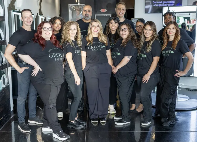A team of stylists dressed in identical black Grove Salon T-shirts.